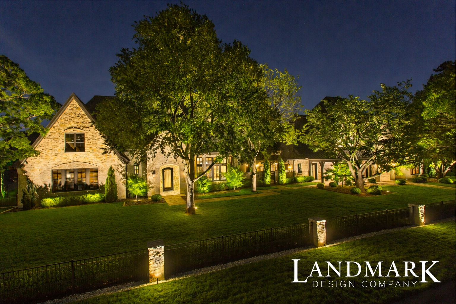 Luxury landscape lighting in Preston Hollow Dallas with warm architectural uplighting